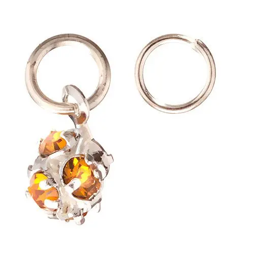 Ozdobný piercing v tvare guľky s oranžovo - hnedými kamienkami